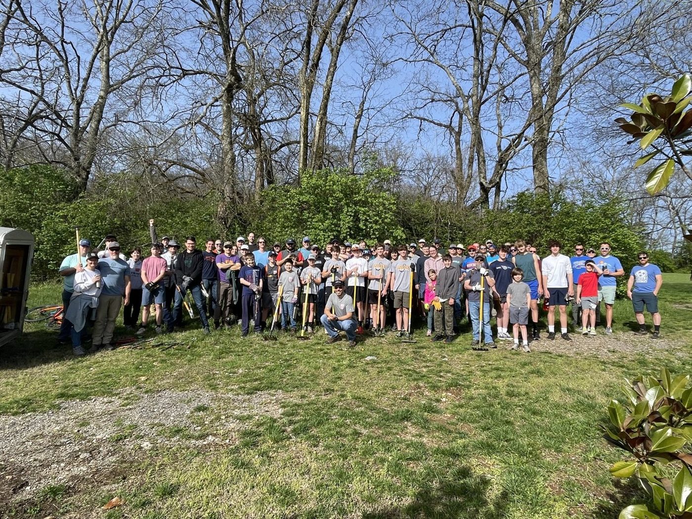Dozens of volunteers with trail tools at a Smith Park workday