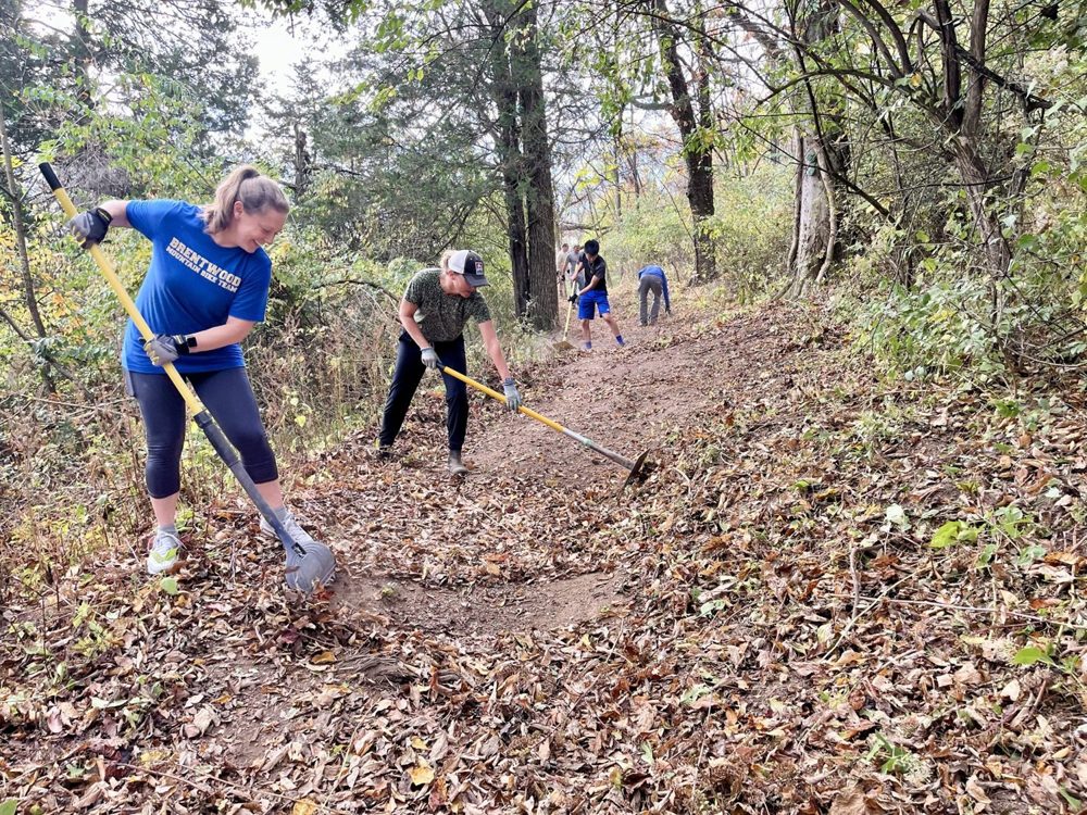 Volunteers raking and shaping trail at a Smith Park workday